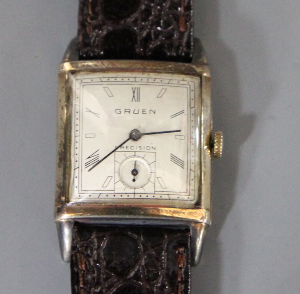 A gentlemans 1930s? 10k gold filled Gruen Precision manual wind wrist watch, with rectangular Roman and baton dial